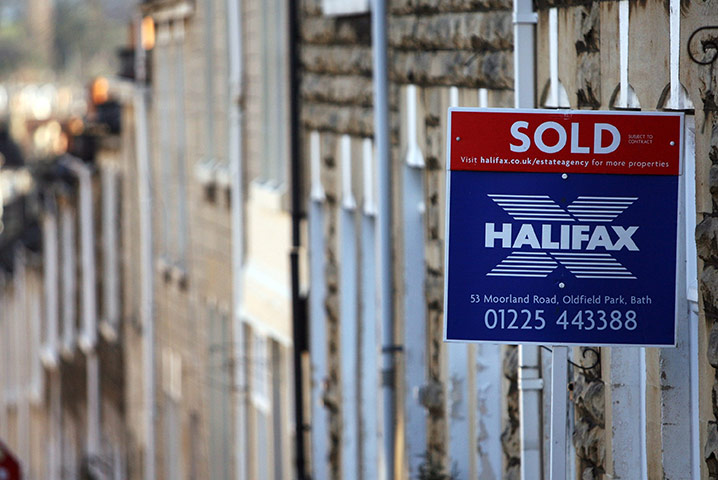Week in Business: A terraced house displays a Halifax estate agent's sold sign in Bath