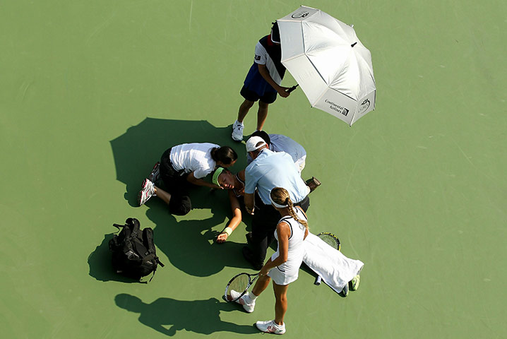 24 hours: Victoria Azarenka of Belarus is tended to by medical  personnel 