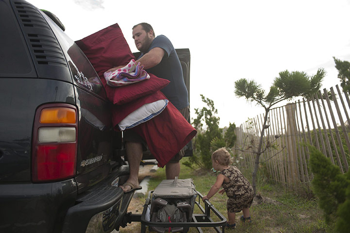 Hurrican Earl Update: Nathan King and his son Ethan vacate a hotel Hurricane Earl approaches