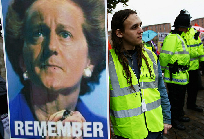 Liberal Democrats : A protester holds a placard during a public services demonstration