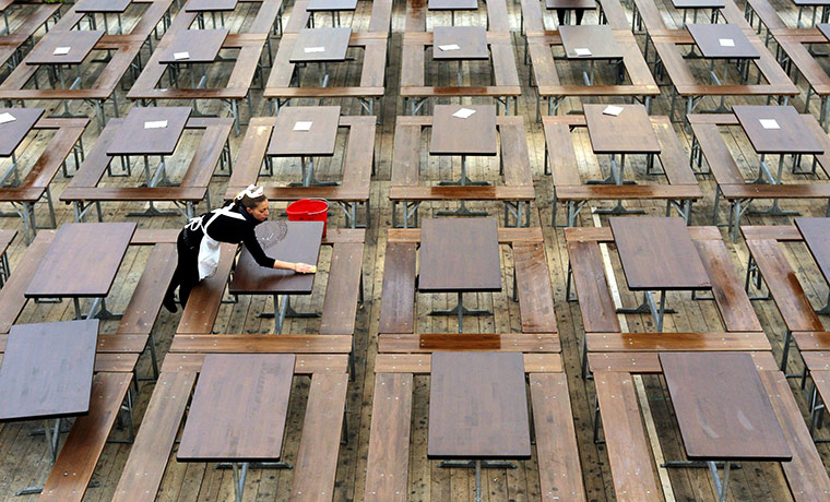 Oktoberfest in Munich: A waitress prepares the tables at the Oktoberfest