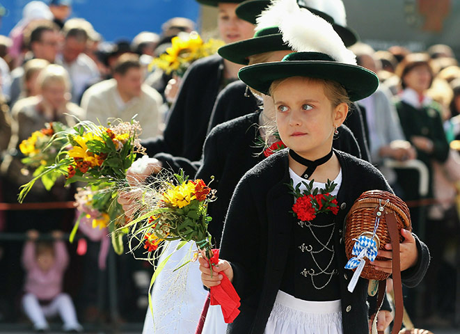 Oktoberfest in Munich: Girls in traditional Bavarian outfit participate in the riflemen's parade
