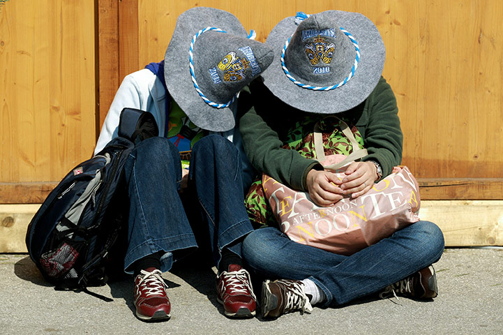 Oktoberfest in Munich: A drunk couple wearing Oktoberfest 2010 hats during day two 
