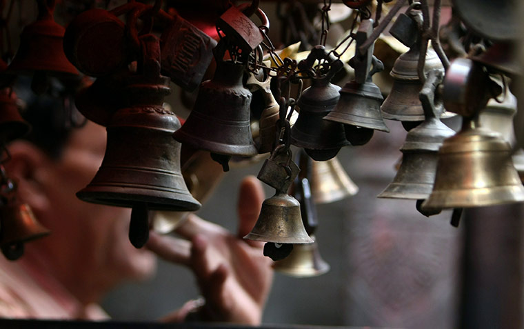 24 hours in pictures: A Nepalese Hindu rings bells for Indra Jatra festival