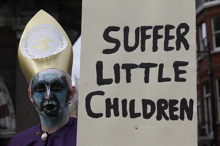 Pope Protestor: A demonstrator holds a banner during a protest against the visit of Pope 