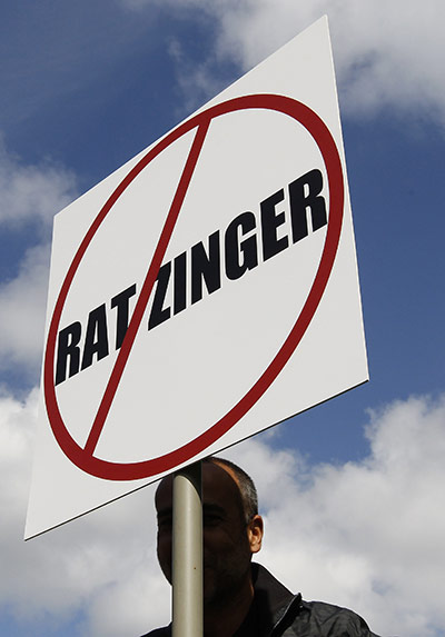 Pope Protestor: A demonstrator holds a banner during a protest