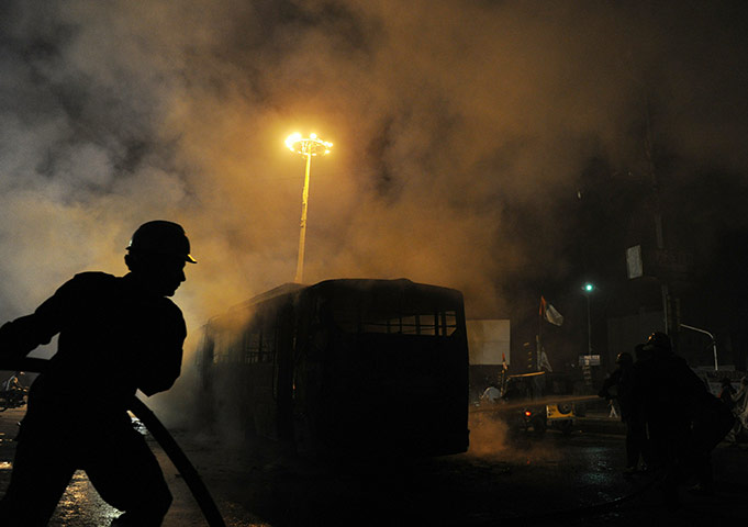 24 hours in pictures: Pakistani firefighters extinguish a burning passenger bus torched by a mob