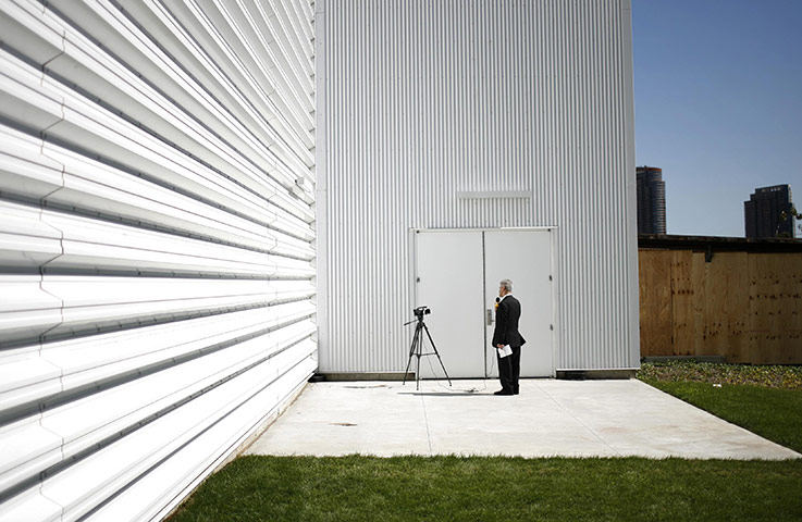 Millennium Development: A television reporter does a standup report outside the media centre