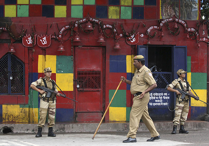 Commonwealth games: Indian security personnel stand guard outside a temple