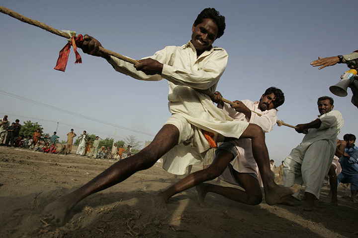 24 hours in pictures: Sukkur, Pakistan: Men displaced by floods take part in a game of tug-of-war