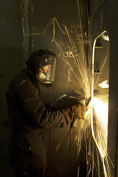 BAE Systems Govan: A fabricator using a grinder at BAE Systems Govan dockyard, Glasgow