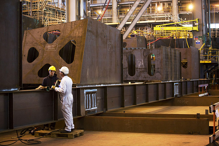 BAE Systems Govan: Shipyard workers with sections of aircraft carrier construction