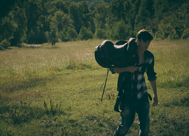 Ranch Fashion: Model carrying sadle
