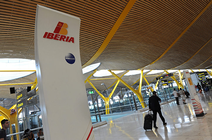 Week In Business: Passengers arrive to check in with Iberia at Barajas airport