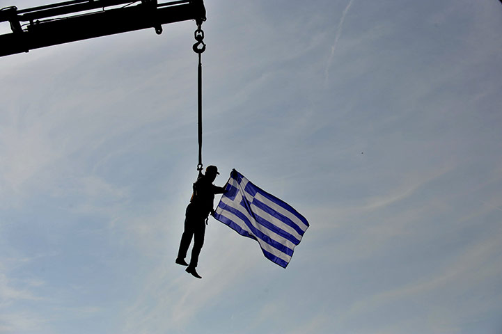 24 hours in pictures: A truck driver and union member waves a Greek flag