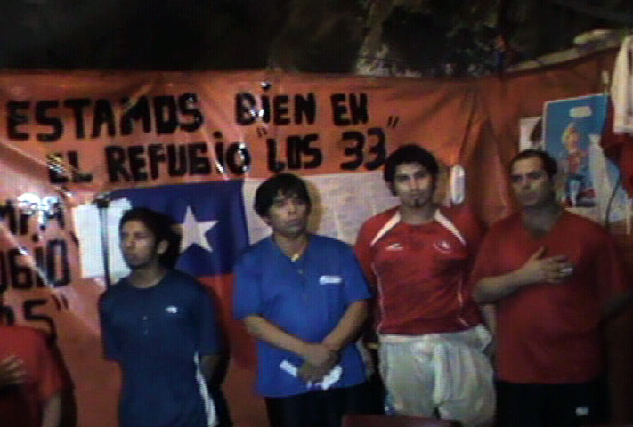 Trapped miners in Chile: 18 Sepember: A video grab of trapped miners singing their nation's anthem