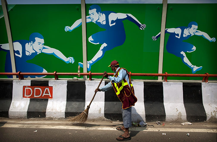 Commonwealth Games Clean: A civic worker sweeps a road outside the Commonwealth Games village