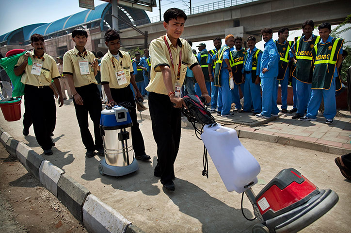 Commonwealth Games Clean: Cleaners stand in a queue to clean the athletes' village in New Delhi