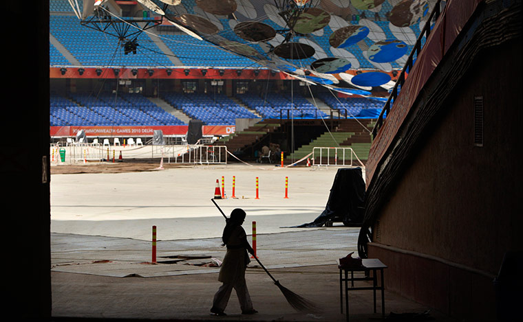 Commonwealth Games Update: A worker sweeps inside the Jawaharlal Nehru Stadium