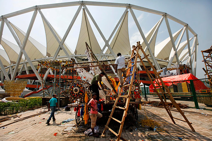 Commonwealth Games Update: Workers prepare a float for the opening ceremony in New Delhi