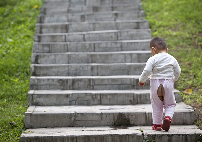 24 hours in pictures: Beijing, China: A  child walks up a flight of stairs in a park