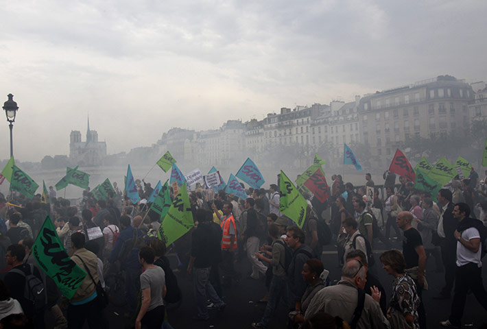 24 hours in pictures: Paris, France: Protestors cross a bridge over the Seine