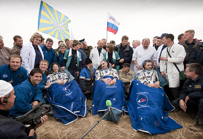 24 Hours: Cosmonauts sit by the Soyuz Capsule just minutes after they landed