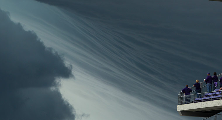 24 Hours: Manhattan, Kansas, USA: Fans watch while a thunderstorm approaches