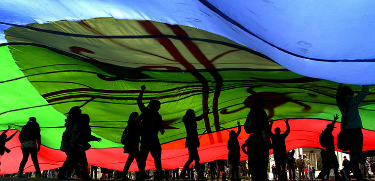 24 Hours: Concepcion, Chile: Demonstrators walk under a Mapuche flag during a march