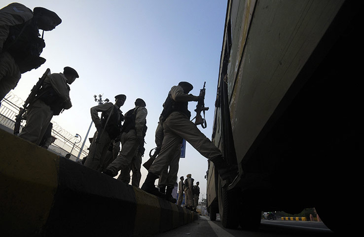 Commonwealth games: Indian security personnel board a bus in front of Jawaharlal Nehru Stadium