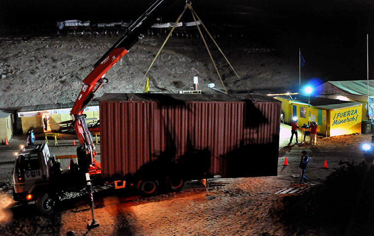 Trapped miners in Chile: 25 September: A crane unloads a module to be used as a school room