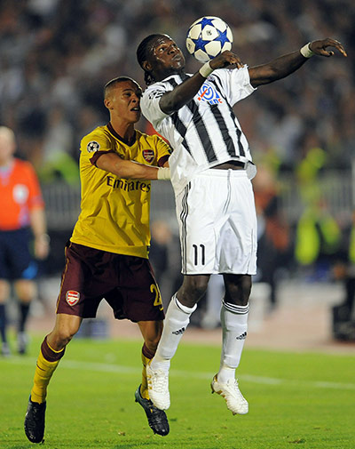 Champions League: Partizan's Pierre Pierre Boya shields the ball from Kieran Gibbs
