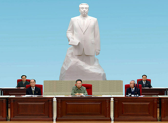 North Korea conference: North Korean leader Kim Jong-Il sits in front of a statue of his father