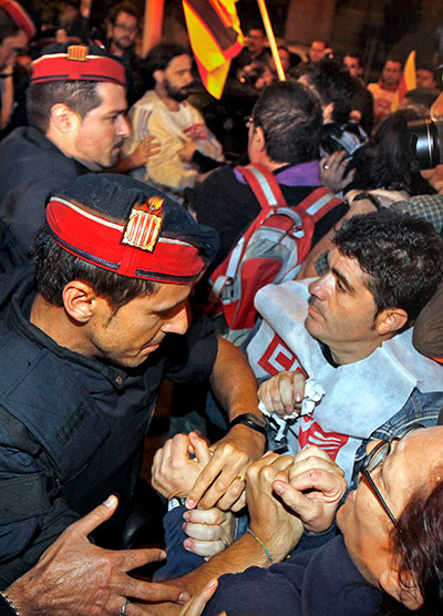 European strikes: Workers at a picket line scuffle with Catalonian regional police, Spain