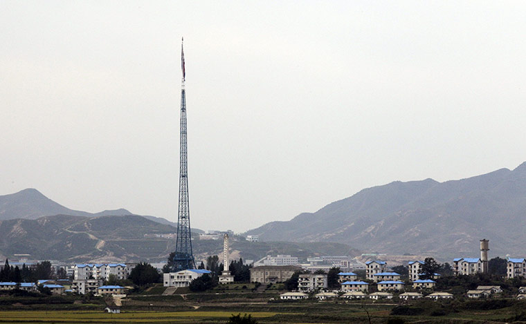 North Korea conference: A North Korean flag is seen atop a 160-metre tower near houses