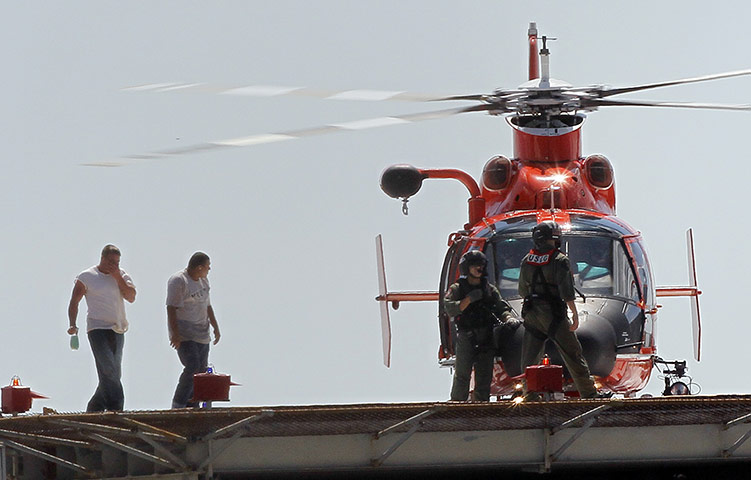 Oil Platform Explosion: Two workers, left, who were rescued from an oil platform that exploded
