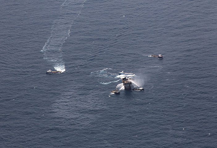 Oil Platform Explosion: Boats spray water on an oil and gas platform that exploded near Louisiana