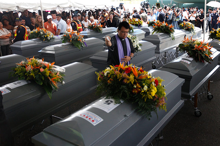 Mexico drug war: Priest blesses coffins of murdered Honduran illegal immigrants