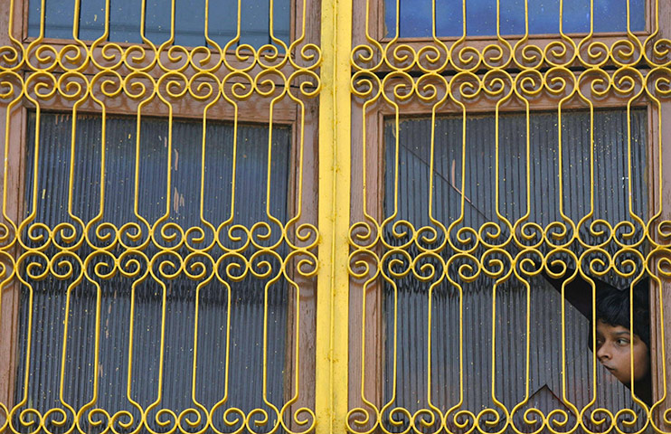 Ayodhya Mosque Update: A boy watches security forces in the northern Indian town of Ayodhya