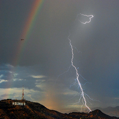 24 hours Thurs: A rainbow and bolts of lightening are shown next to the Hollywood in LA