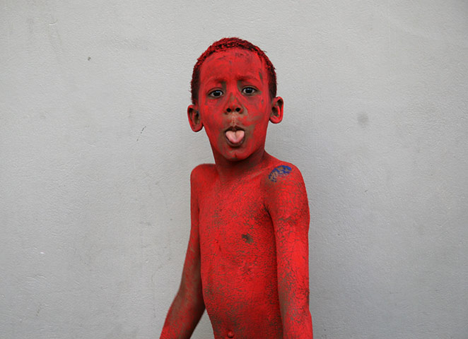 In Pictures: Red: young boy in red dye at Trinidad Carnival