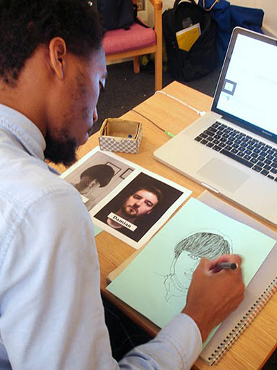 Liverpool Road: A young man works at a desk on his designs