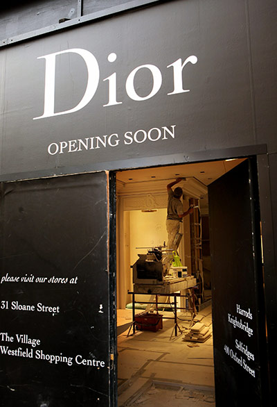 Week in Business: Workmen construct a new Dior shop on New Bond Street in Mayfair