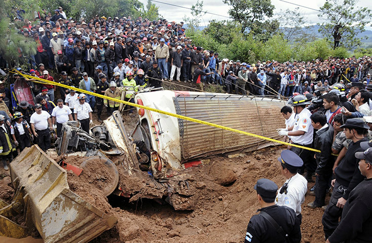 Guatemala Landslide: People surround a bus Guatemala