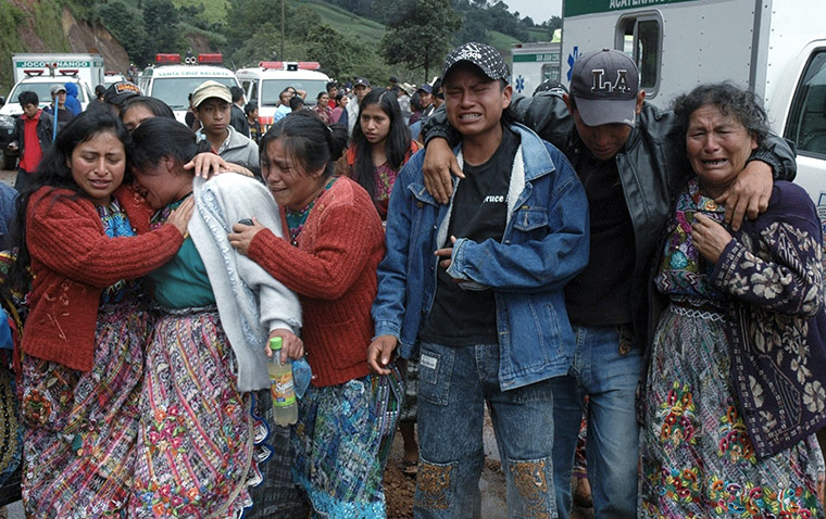 Guatemala Landslide: Relatives cry where a bus was buried Guatemala