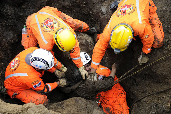 Guatemala Landslide: Workers remove a landslide victims Guatemala