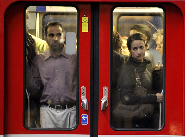 French Strikes: Commuters looks through the window of a subway train in Paris