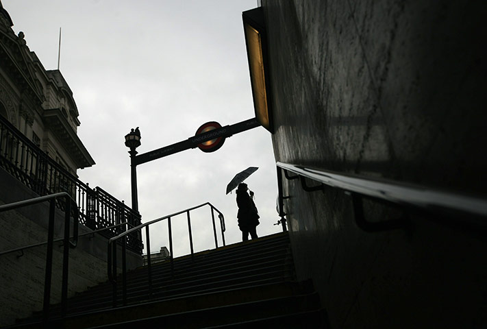 Tube stirke: A commuter leaves the Underground tube station at Piccadilly Circus