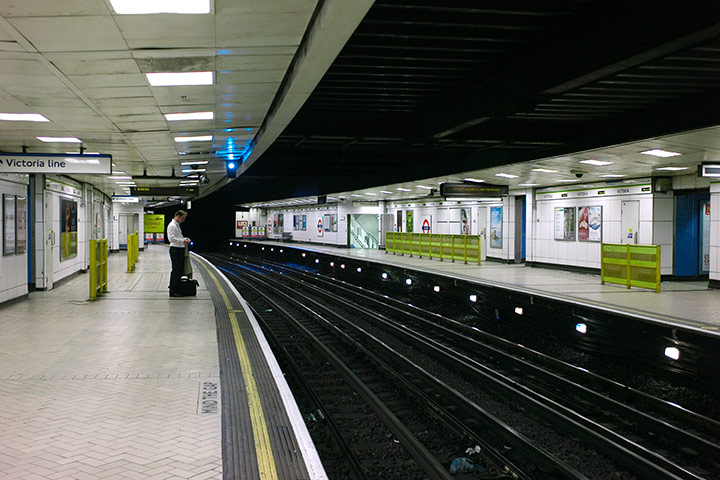 Tube stirke: A commuter waits on a empty platform at the closed Victoria underground