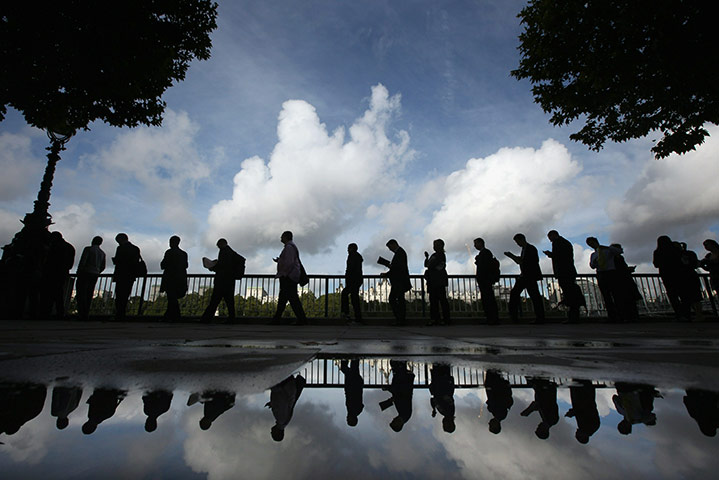 Tube stirke: Commuters queue for the water taxi from the London Eye Pier